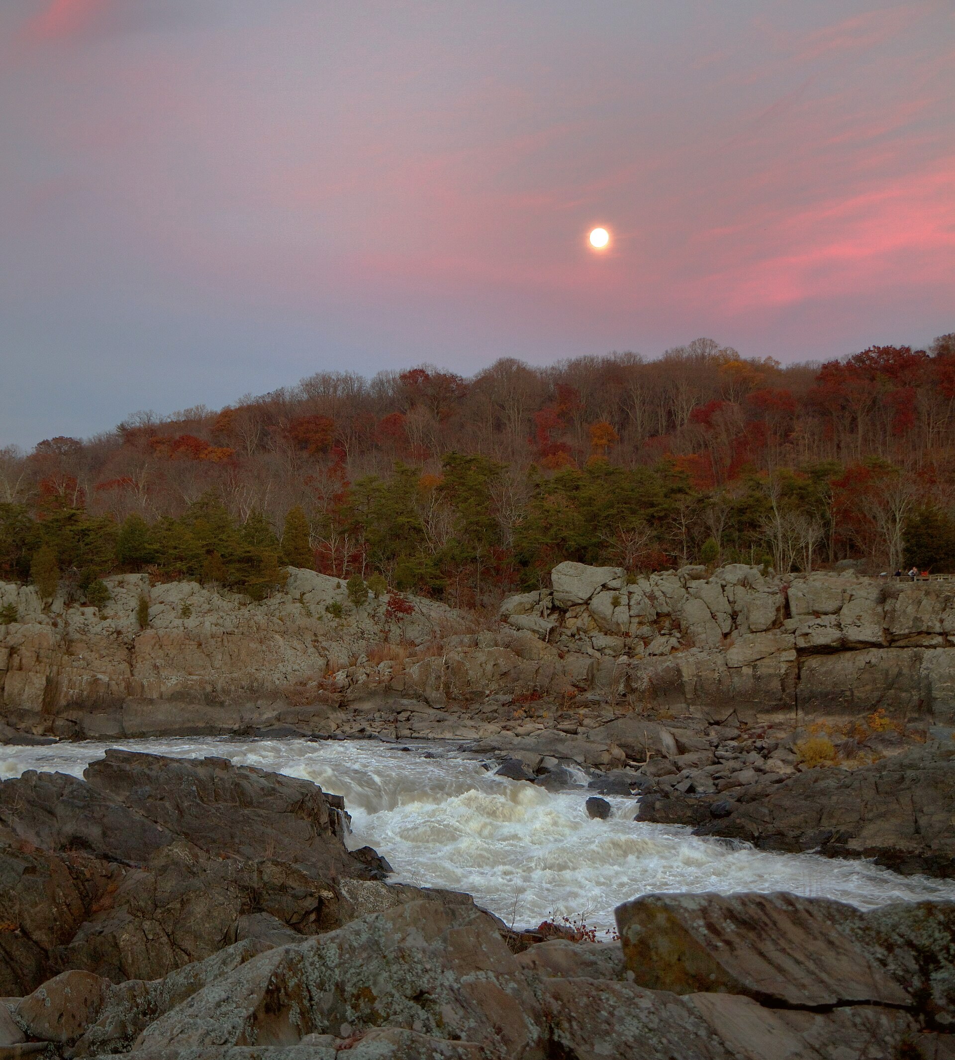 A full moon rising over the Great Falls of the Potomac at dusk